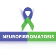 A purple and green ribbon with the word neurofibromatosis underneath.